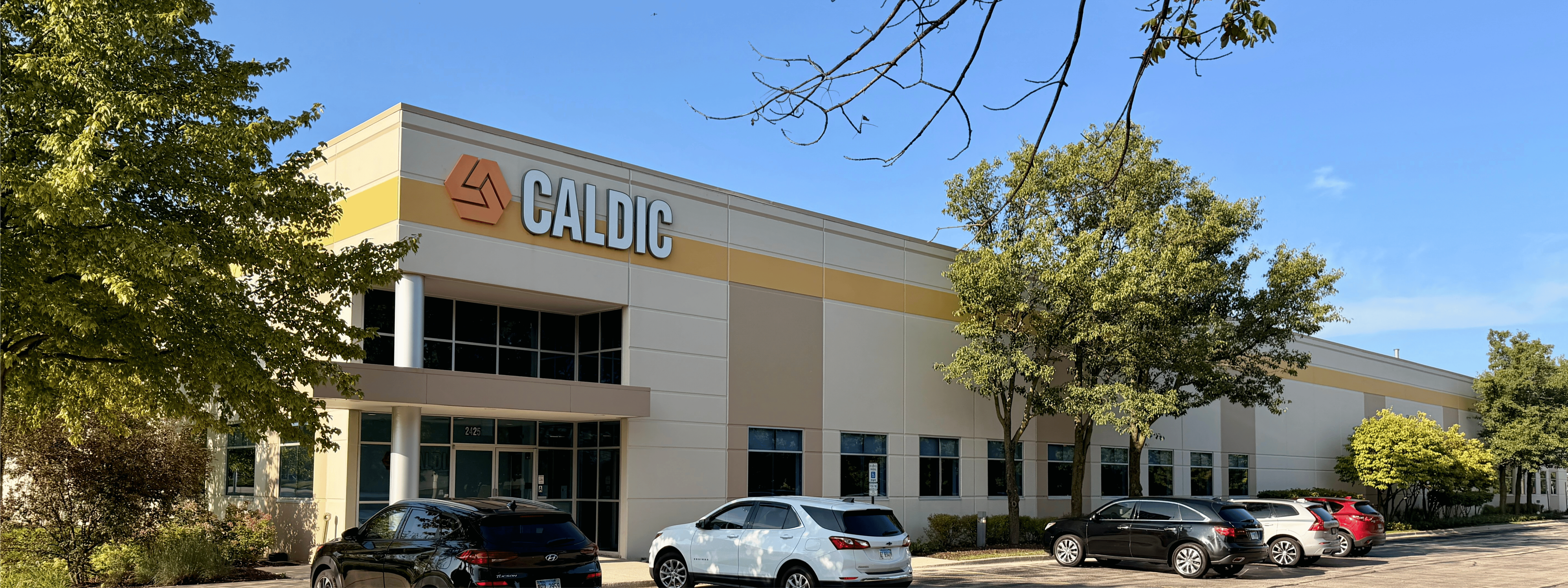 Caldic corporate office and distribution facility with modern glass frontage, landscaped grounds, and parking area