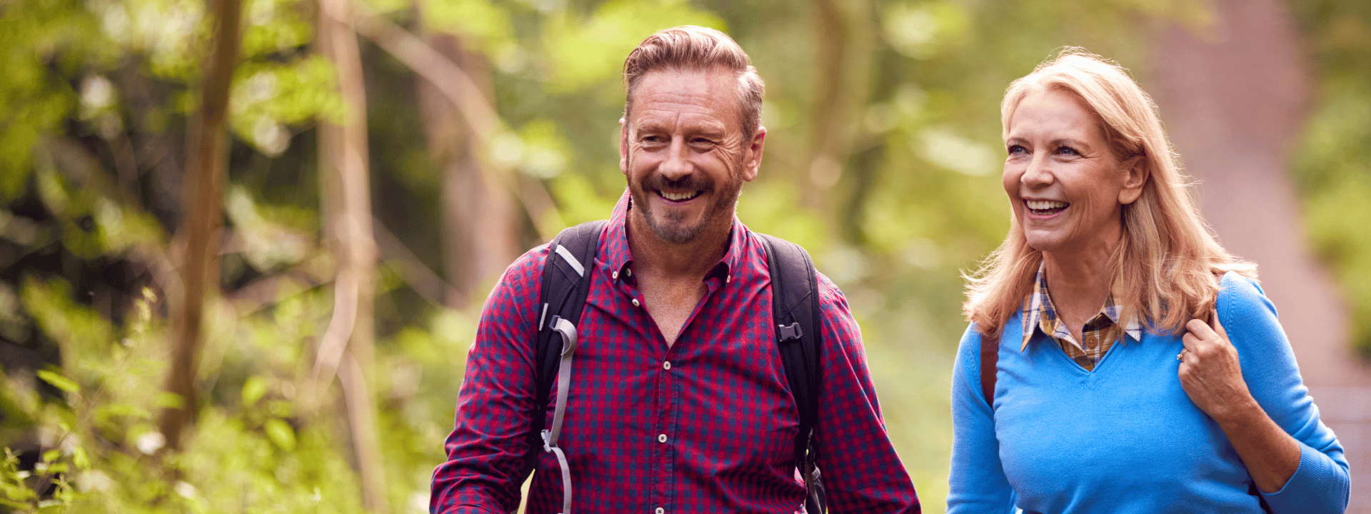 Active middle-aged couple hiking in nature representing healthy aging and vitality supported by nutrition ingredients